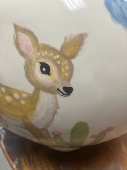 Ceramic container with a deer illustration on a white background