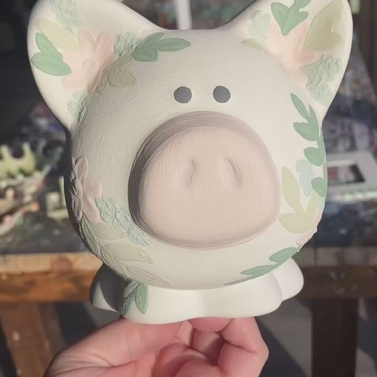 video of custom painted piggy bank before and after firing
