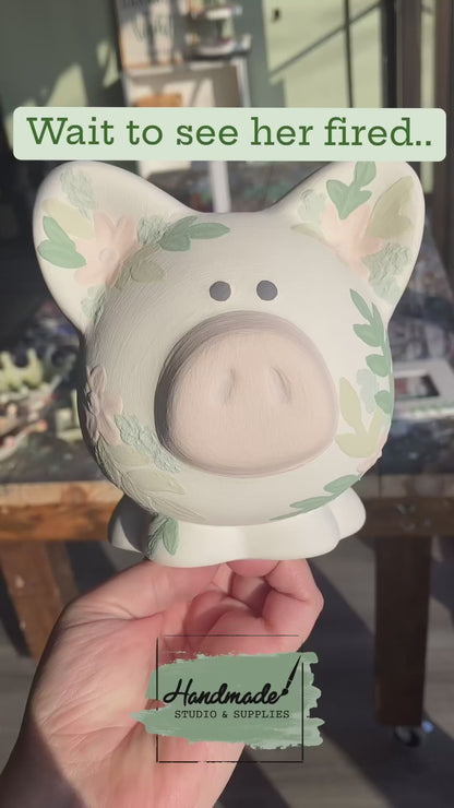 video of custom painted piggy bank before and after firing